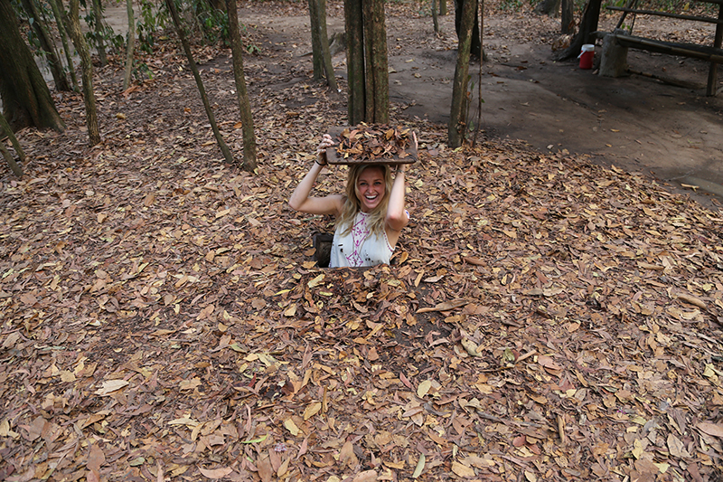 A narrow tunnel entrance with wooden lid covered under dried leaves appears almost invisible to untrained eyes.